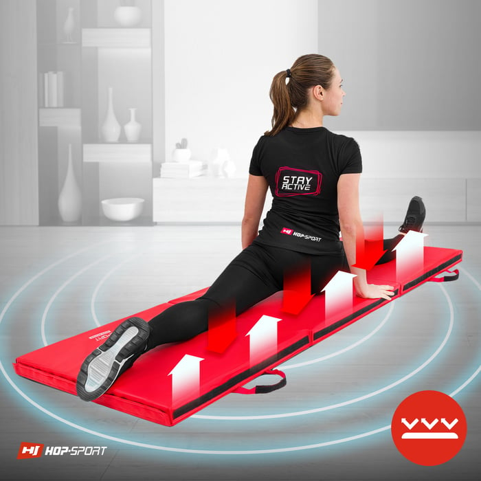 Dziewczyna ćwicząca na antypoślizgowym materacu gimnastycznym marki Hop-Sport w kolorze czerwonym
